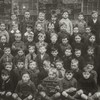 A classic group portrait of schoolchildren and teachers from the 1920s, in black and white.